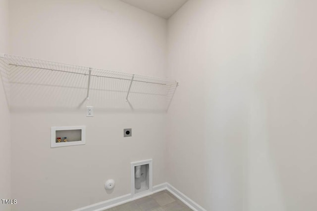 washroom featuring gas dryer hookup, hookup for a washing machine, laundry area, baseboards, and electric dryer hookup