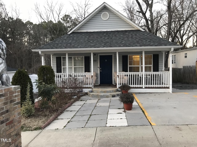 view of front facade featuring a porch and roof with shingles