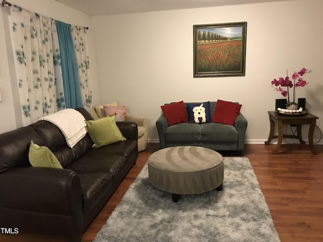 living area featuring baseboards and wood finished floors