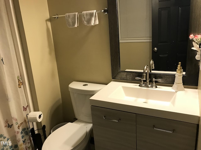 bathroom featuring toilet and vanity