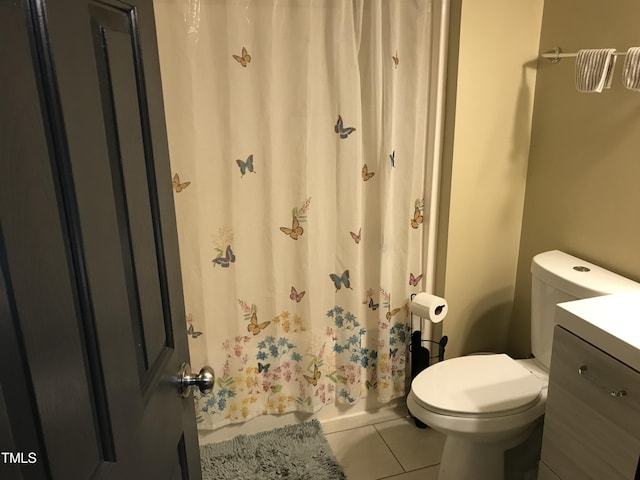 bathroom with vanity, tile patterned flooring, and toilet