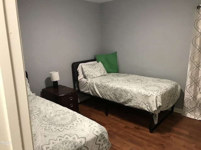 bedroom featuring dark wood finished floors