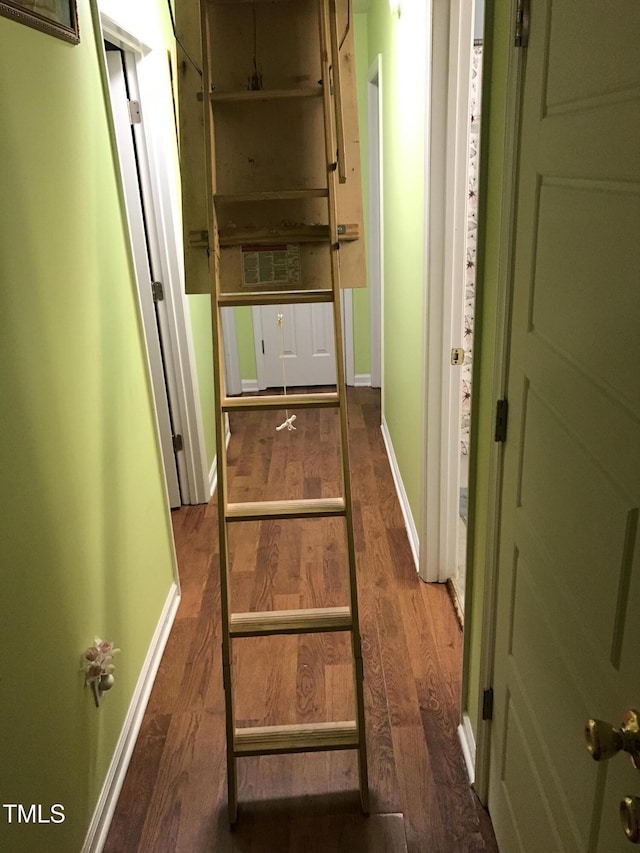 hall with wood finished floors and baseboards