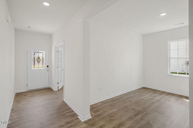 entrance foyer with baseboards, wood finished floors, and recessed lighting