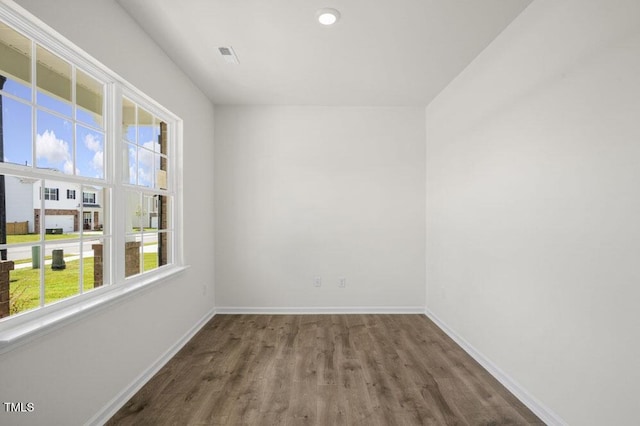 empty room with wood finished floors and baseboards