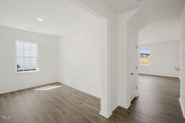 unfurnished room featuring dark wood-style floors and baseboards