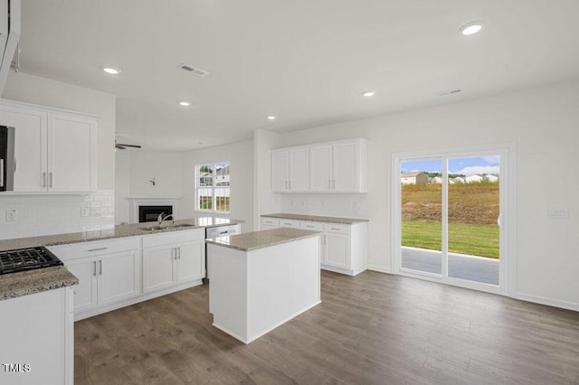 kitchen featuring recessed lighting, dark wood-style flooring, white cabinets, and decorative backsplash