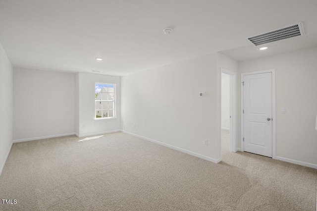 unfurnished room featuring baseboards, visible vents, and carpet flooring