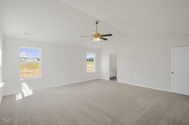 empty room featuring a ceiling fan, visible vents, vaulted ceiling, baseboards, and carpet