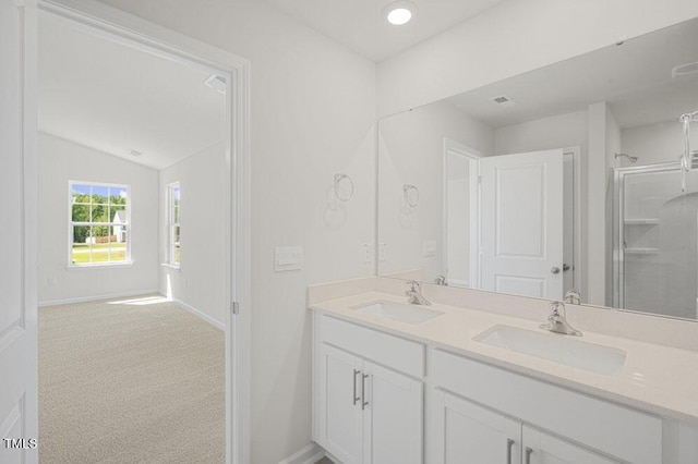 bathroom featuring double vanity, a sink, and baseboards