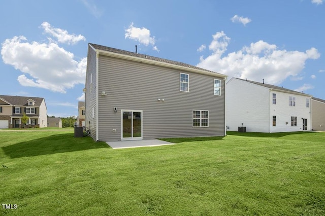 rear view of property with a lawn, a patio, and central air condition unit