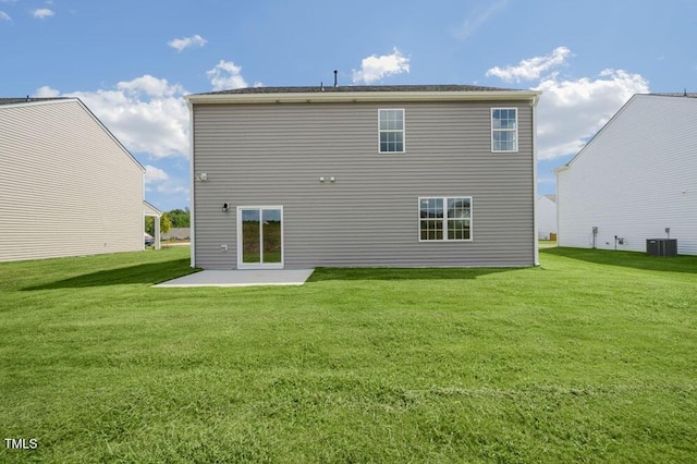 back of house featuring central air condition unit, a lawn, and a patio