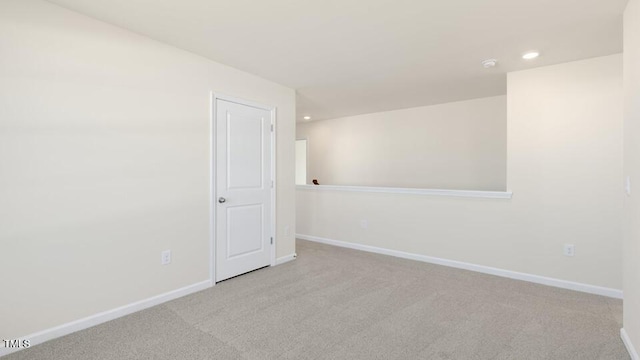 empty room with recessed lighting, carpet flooring, and baseboards