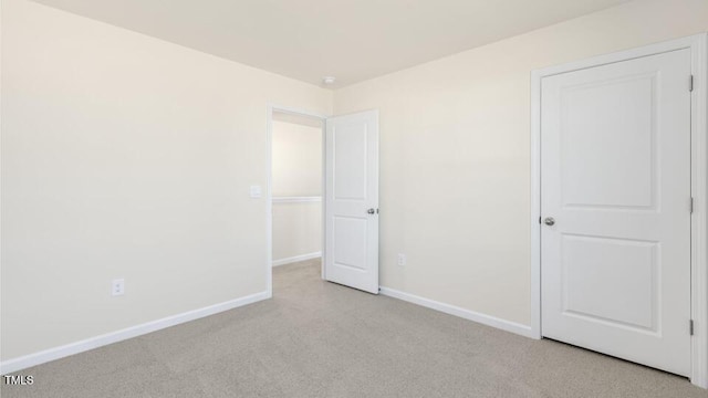 unfurnished bedroom featuring carpet floors and baseboards