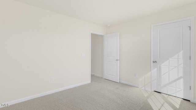 unfurnished bedroom with carpet and baseboards