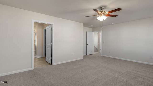 unfurnished bedroom with light carpet, a ceiling fan, and baseboards