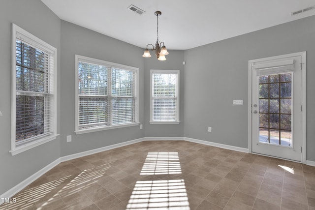 unfurnished dining area with baseboards, tile patterned flooring, visible vents, and a notable chandelier