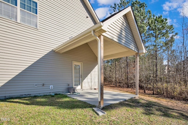 view of property exterior with a patio and a yard