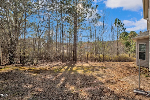 view of yard featuring a wooded view