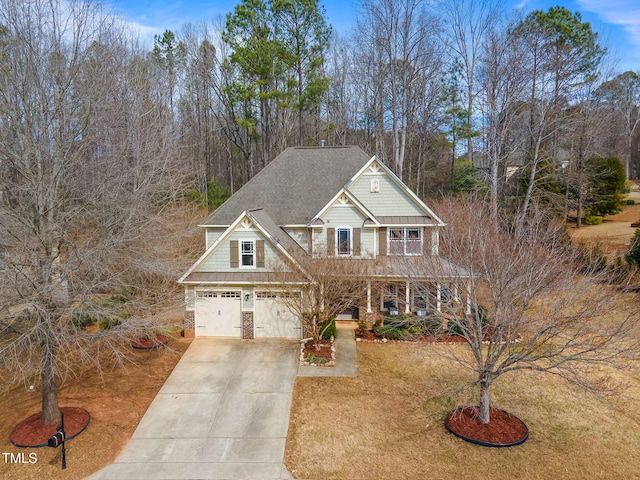 craftsman house with covered porch, stone siding, concrete driveway, and roof with shingles