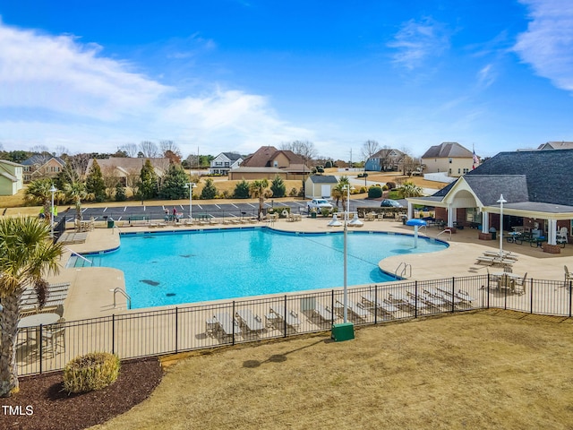 pool featuring a patio area, a residential view, and fence