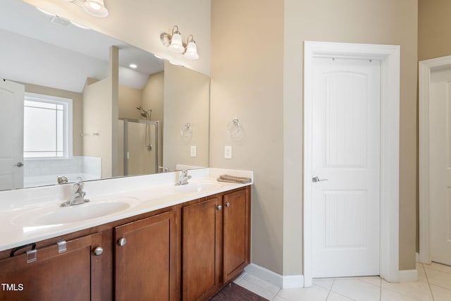 bathroom with double vanity, tile patterned flooring, a sink, and a shower stall