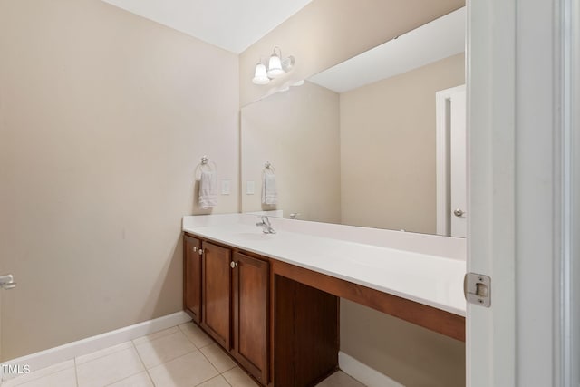 bathroom with baseboards, vanity, and tile patterned floors