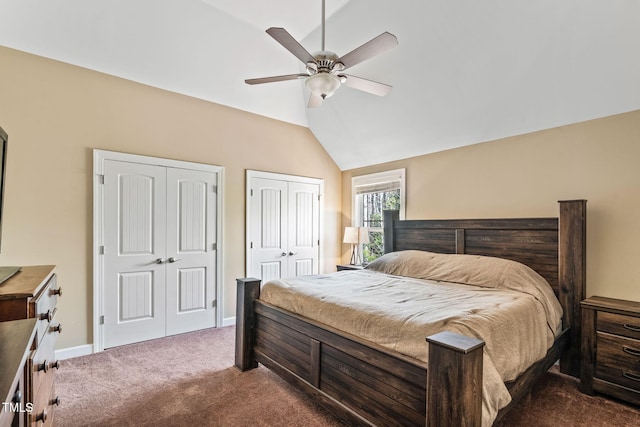 bedroom featuring multiple closets, dark colored carpet, vaulted ceiling, ceiling fan, and baseboards