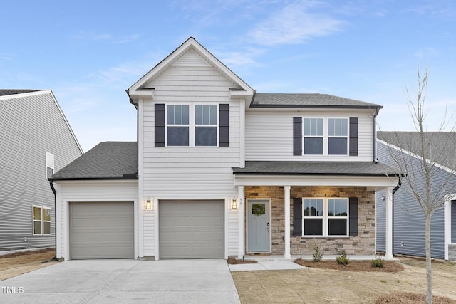 view of front of property featuring driveway, a shingled roof, a porch, and stone siding