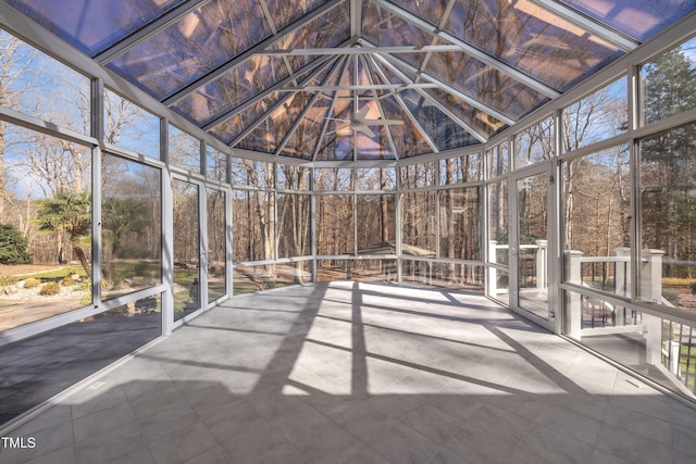 unfurnished sunroom with lofted ceiling