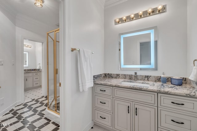 bathroom with ornamental molding, a stall shower, vanity, and baseboards