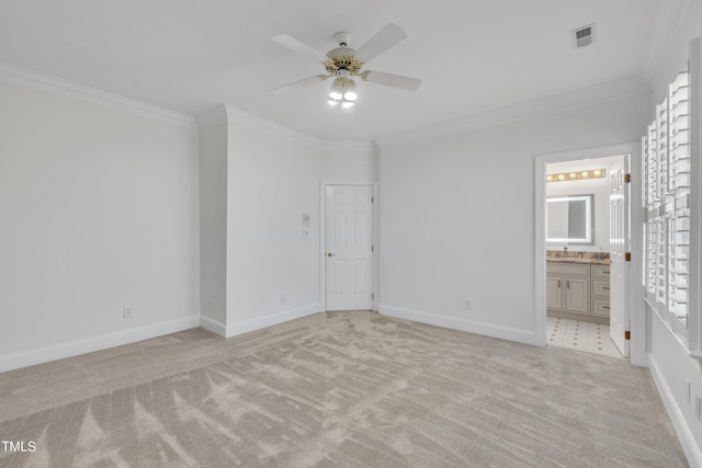 unfurnished bedroom with baseboards, visible vents, crown molding, and light colored carpet