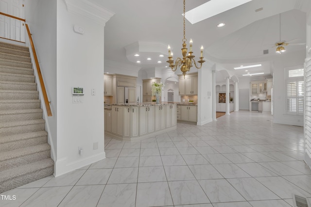 unfurnished living room featuring visible vents, arched walkways, stairway, ornamental molding, and ceiling fan with notable chandelier