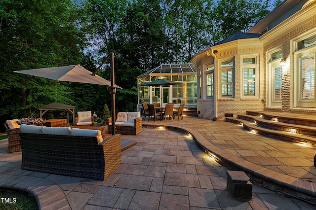 view of patio with outdoor dining space, an outdoor hangout area, and a gazebo