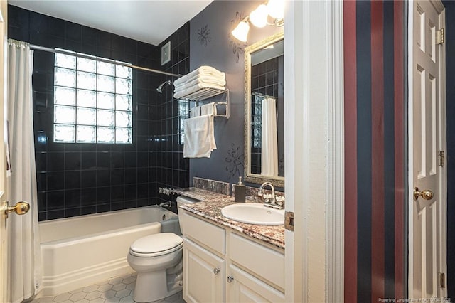 bathroom featuring toilet, tile patterned flooring, vanity, and shower / bathtub combination with curtain