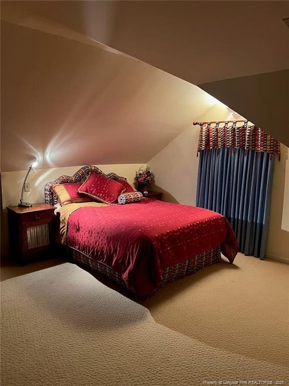 carpeted bedroom featuring vaulted ceiling