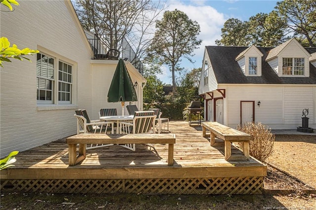 wooden deck featuring outdoor dining space