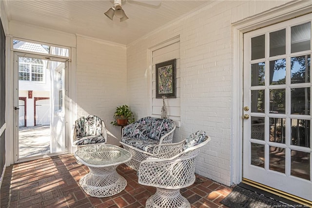 sunroom / solarium with a ceiling fan