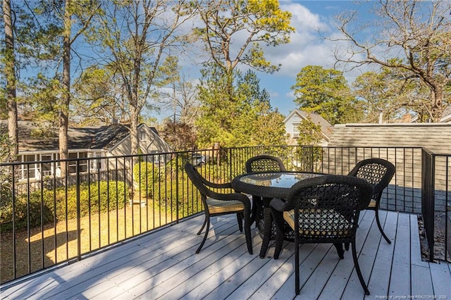 wooden terrace with outdoor dining area