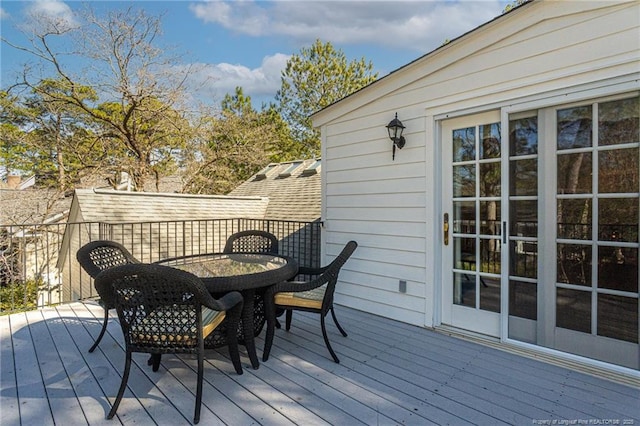 wooden terrace featuring outdoor dining area