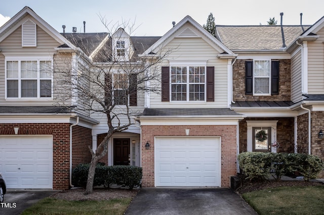 view of property with concrete driveway, brick siding, a garage, and roof with shingles