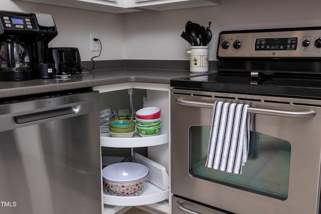 kitchen featuring dark countertops and appliances with stainless steel finishes