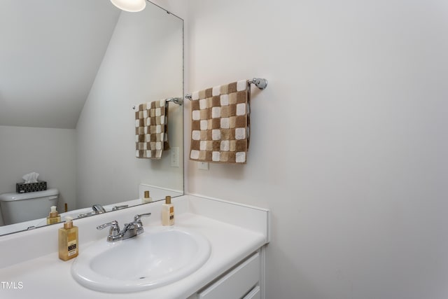 half bath featuring vanity, lofted ceiling, and toilet