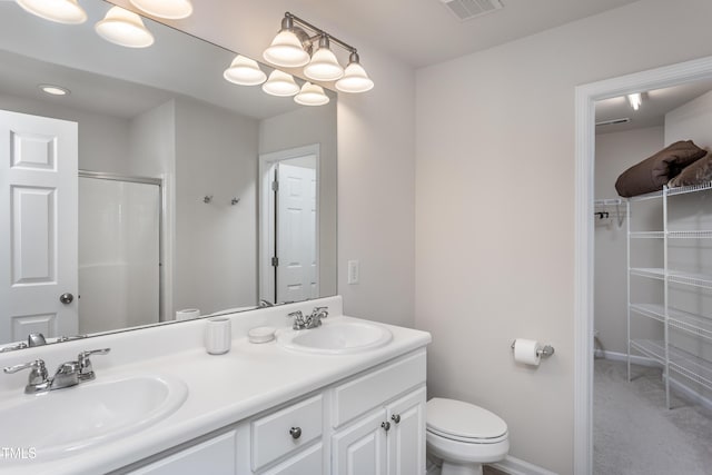 full bath with a sink, visible vents, an enclosed shower, and double vanity