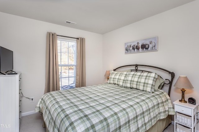 carpeted bedroom with visible vents and baseboards