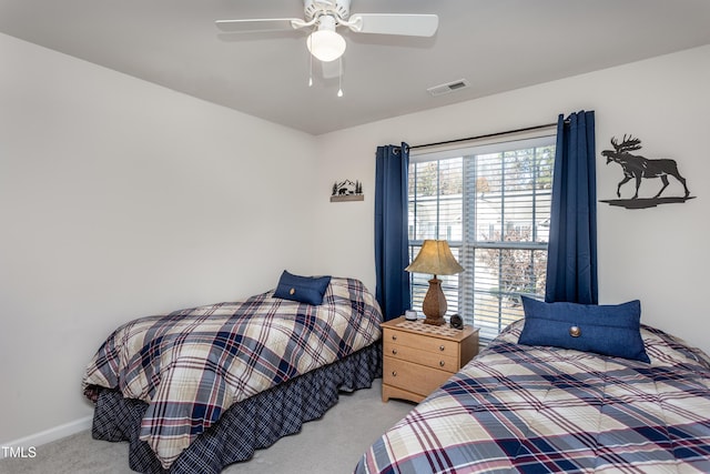 bedroom with baseboards, a ceiling fan, and carpet