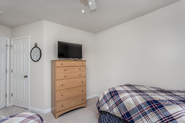 bedroom with baseboards, light colored carpet, and ceiling fan