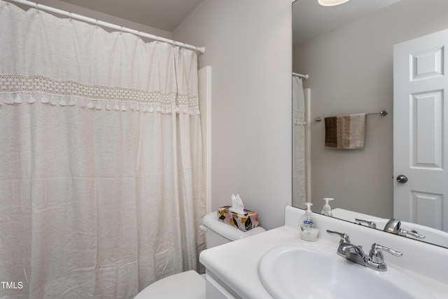 bathroom featuring toilet and vanity