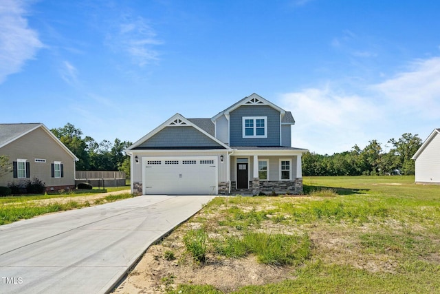 craftsman-style home featuring driveway, stone siding, an attached garage, a front lawn, and board and batten siding