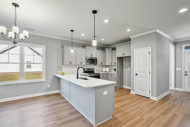 kitchen with light stone counters, stainless steel appliances, backsplash, light wood-type flooring, and a peninsula